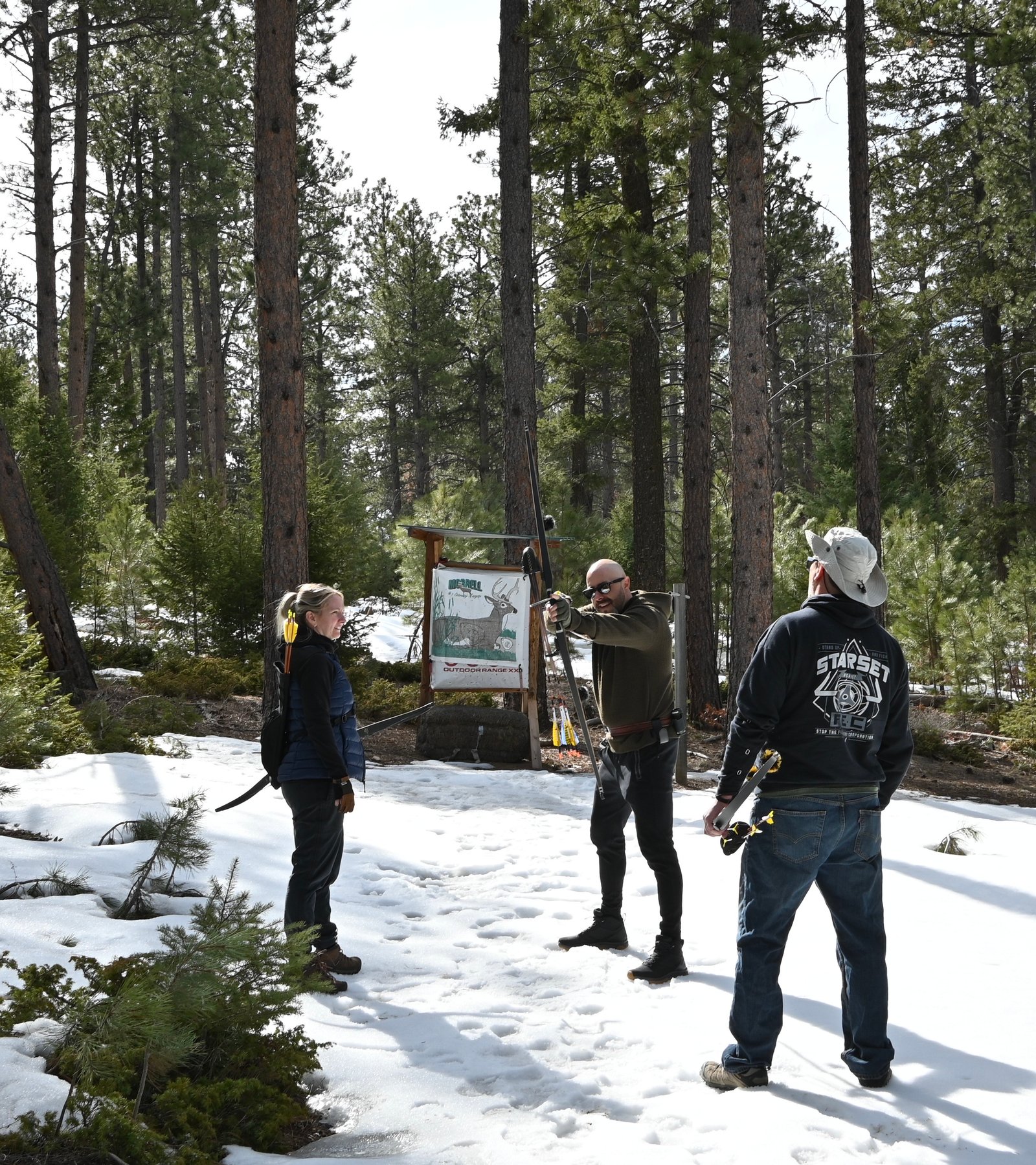 Three archers at the outdoor range in the snow