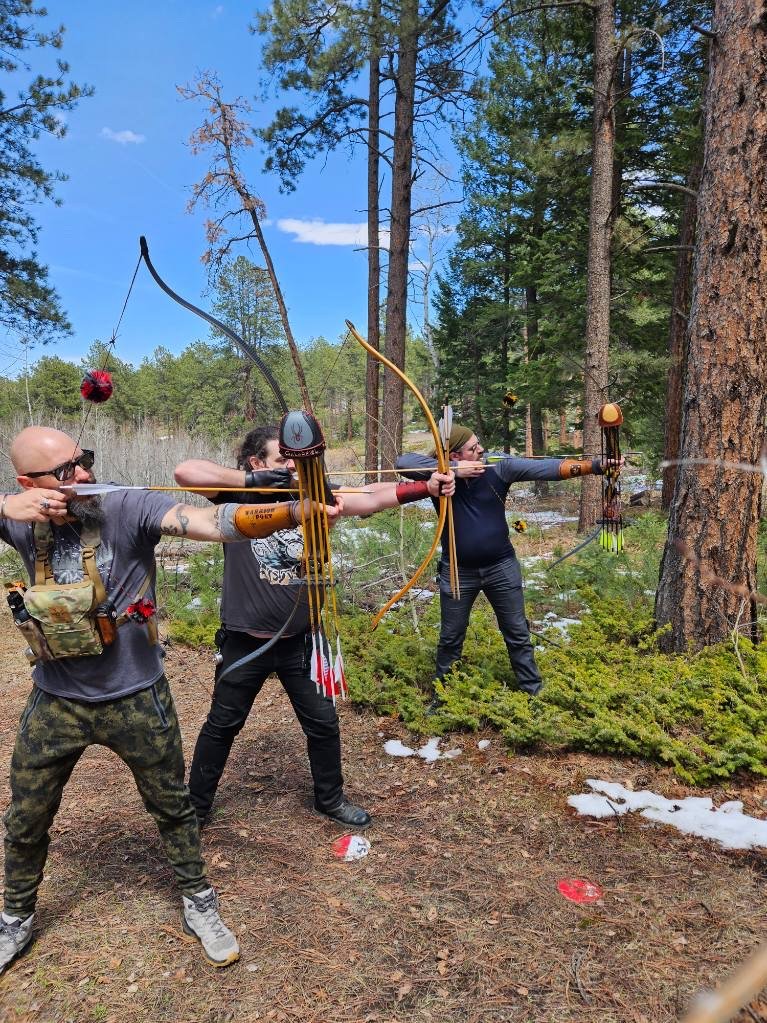 Three archers at full draw