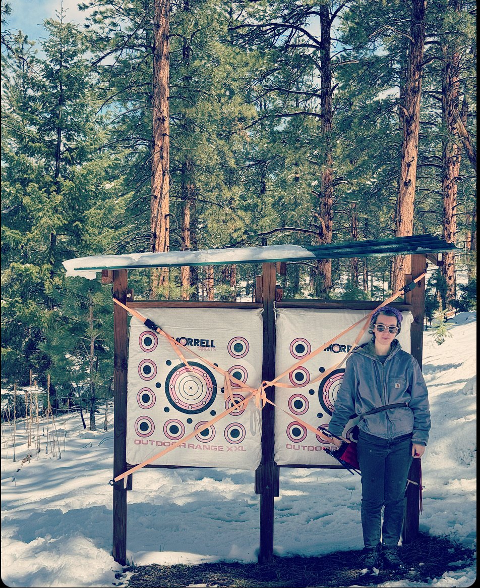 Archer beside the outdoor target stand in winter