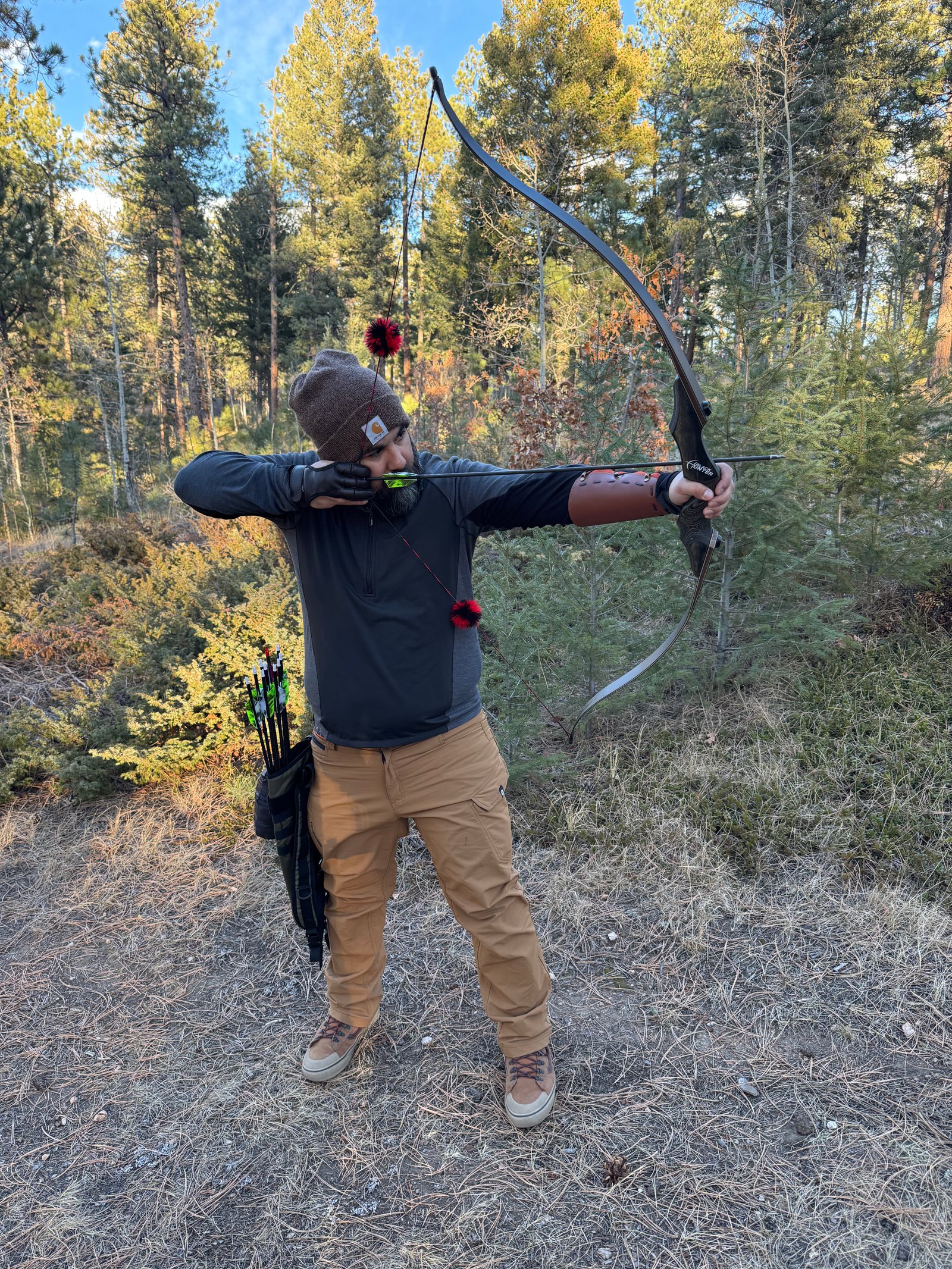 Archer at full draw in golden hour light